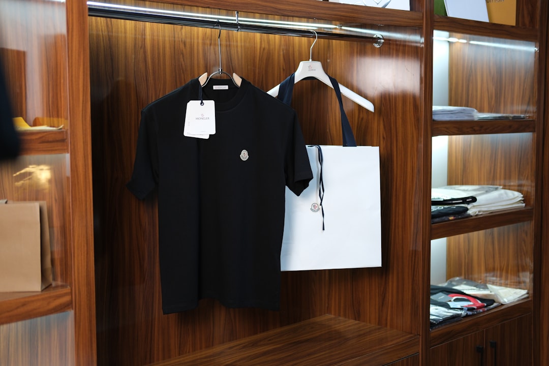 black-t-shirt-and-white-tote-bag-hanging-in-wooden-closet-8zy5ymykdn0